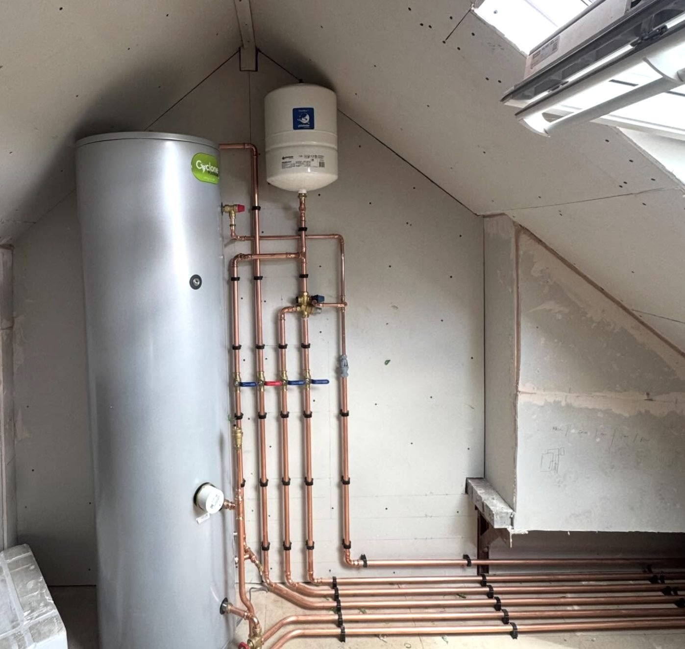 Unvented hot water cylinder with neat copper pipework
